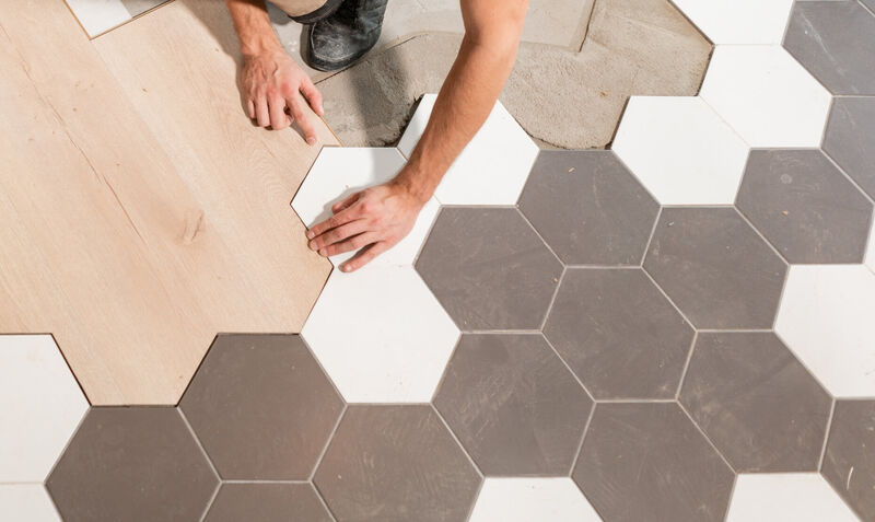 Man installing octagonal tile flooring